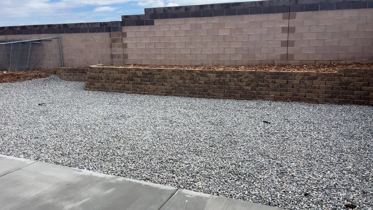 Stacked block planter wall with gravel in front