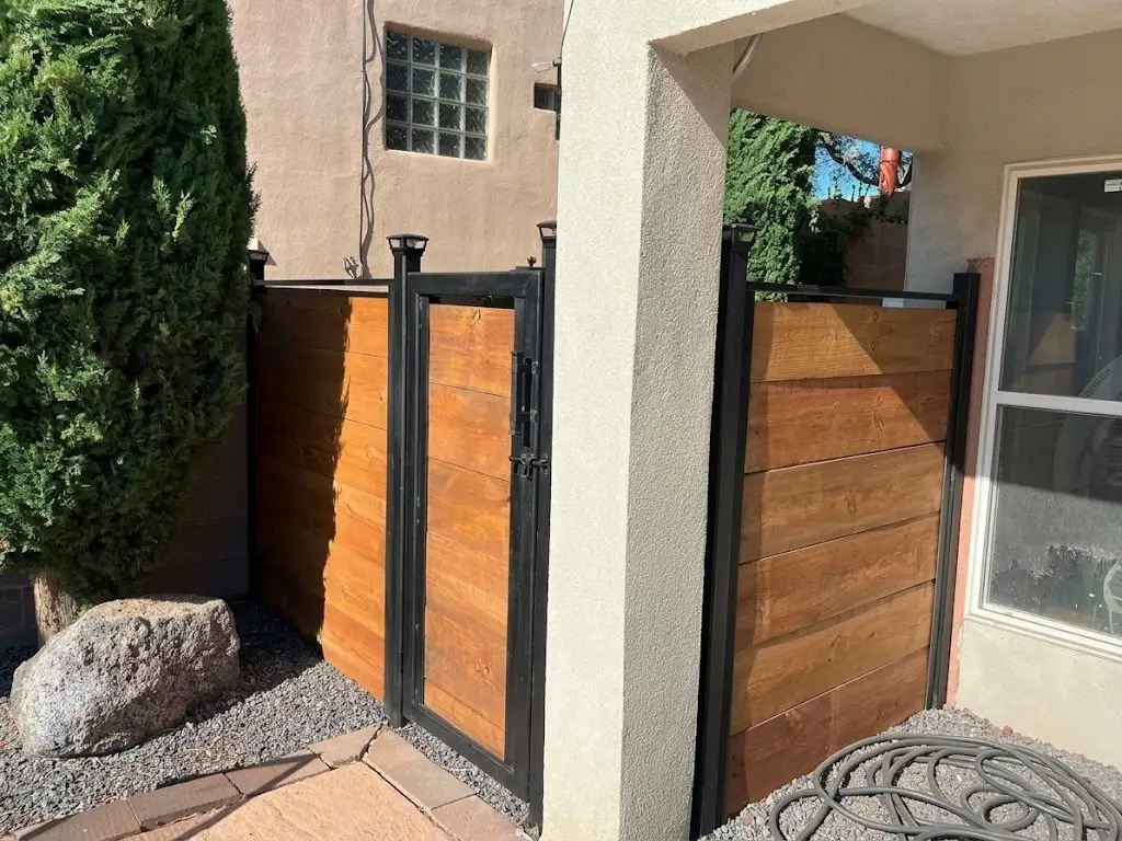 Custom steel-frame fence and gate with horizontal stained wood panels
