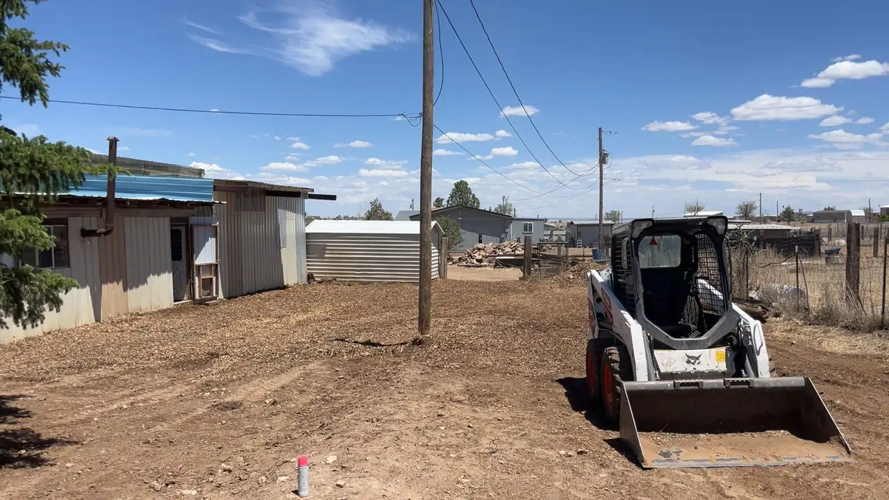 Skid steer grading a cleared lot